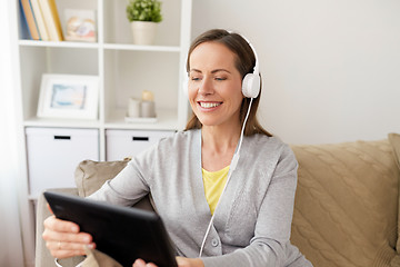 Image showing happy woman with tablet pc and headphones at home