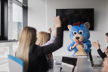 Image showing boss dresed as bear having fun with business people in trendy of