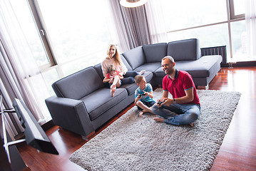 Image showing Happy family playing a video game