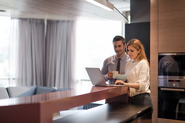 Image showing A young couple is preparing for a job and using a laptop