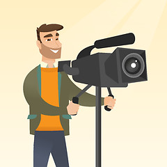 Image showing Cameraman with a movie camera on tripod.