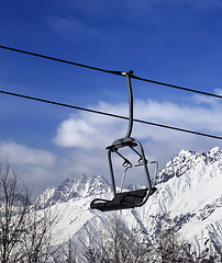 Image showing Ski lift in snow winter mountains at nice sun day
