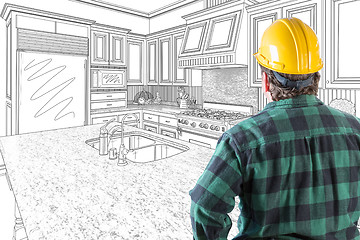 Image showing Male Contractor with Hard Hat Looking At Custom Kitchen Drawing 