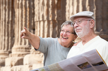 Image showing Happy Senior Adult Couple Tourists with Brochure Next To Ancient