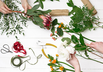 Image showing Female florist making beautiful bouquet at flower shop