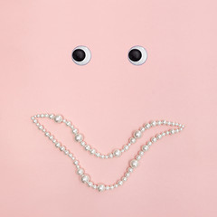 Image showing Shiny pearl smile on pink background