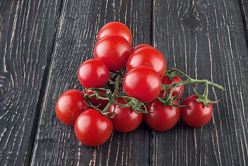 Image showing Two branches of cherry tomatoes