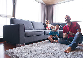 Image showing Happy family playing a video game