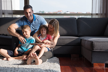 Image showing happy young couple spending time with kids