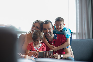 Image showing happy young couple spending time with kids