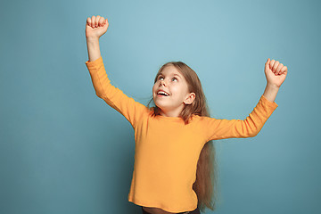 Image showing Win - emotional blonde teen girl have a happiness look and toothy smiling. Studio shot