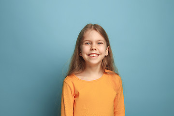 Image showing Win - emotional blonde teen girl have a happiness look and toothy smiling. Studio shot