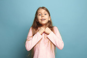 Image showing Win - emotional blonde teen girl have a happiness look and toothy smiling. Studio shot