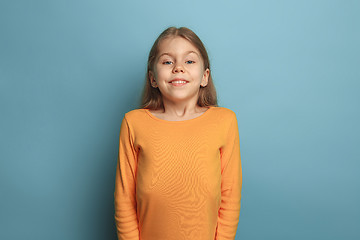 Image showing The surprise, happiness, joy, victory, success and luck. Teen girl on a blue background. Facial expressions and people emotions concept