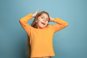 Image showing Win - emotional blonde teen girl have a happiness look and toothy smiling. Studio shot