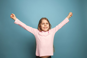 Image showing Win - emotional blonde teen girl have a happiness look and toothy smiling. Studio shot