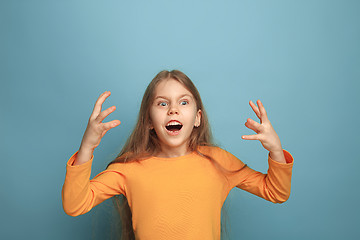 Image showing Win - emotional blonde teen girl have a happiness look and toothy smiling. Studio shot