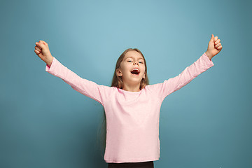 Image showing Win - emotional blonde teen girl have a happiness look and toothy smiling. Studio shot