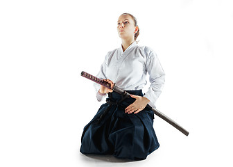 Image showing Aikido master practices defense posture. Healthy lifestyle and sports concept. Woman in white kimono on white background.