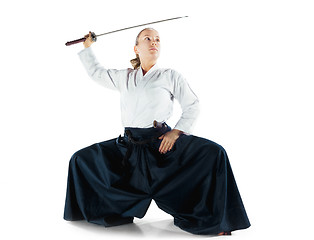 Image showing Aikido master practices defense posture. Healthy lifestyle and sports concept. Woman in white kimono on white background.