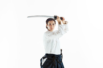 Image showing Aikido master practices defense posture. Healthy lifestyle and sports concept. Woman in white kimono on white background.