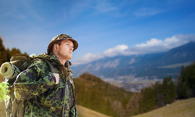 Image showing soldier in military uniform with backpack hiking