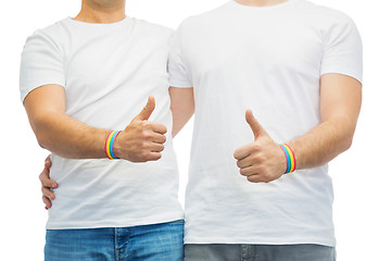 Image showing gay couple with rainbow wristbands shows thumbs up