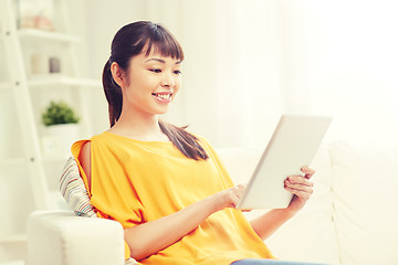 Image showing happy young asian woman with tablet pc at home