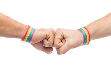 Image showing hands with gay pride wristbands make fist bump