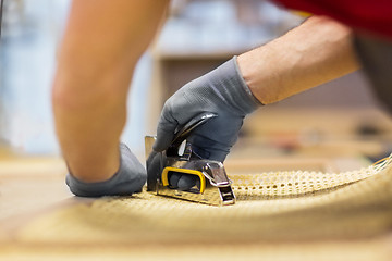 Image showing assembler with staple gun making furniture