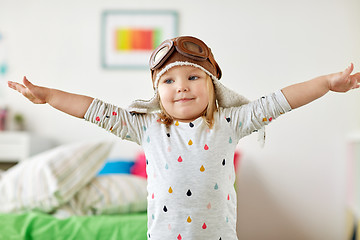 Image showing happy little girl in pilot hat playing at home