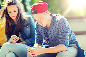 Image showing teenage friends with smartphones outdoors