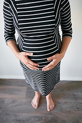 Image showing Pregnant woman in striped dress