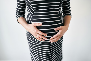 Image showing Pregnant woman in striped dress