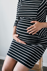 Image showing Pregnant woman in striped dress