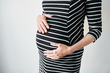 Image showing Pregnant woman in striped dress