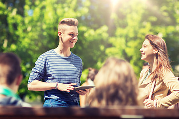 Image showing group of teenage students with tablet pc outoors