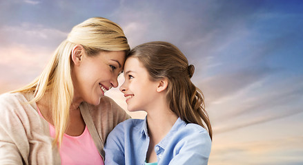 Image showing happy smiling mother and daughter over sky