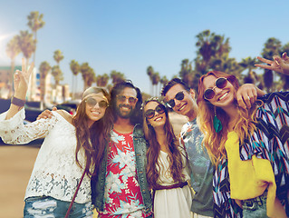 Image showing hippie friends showing peace over venice beach 