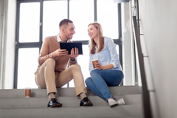 Image showing man and woman with tablet pc and coffee on stairs