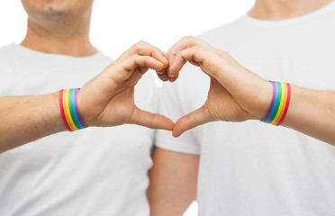 Image showing gay couple with rainbow wristbands and hand heart