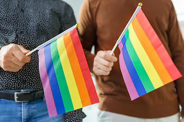 Image showing close up of male couple with gay pride flags