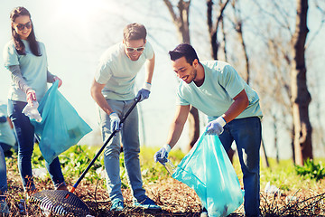 Image showing volunteers with garbage bags cleaning park area