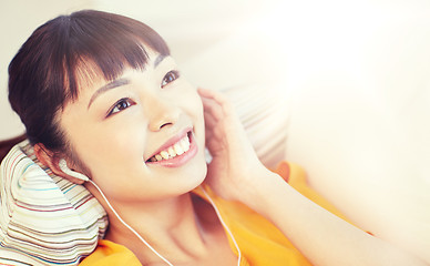 Image showing happy asian woman with earphones listening music