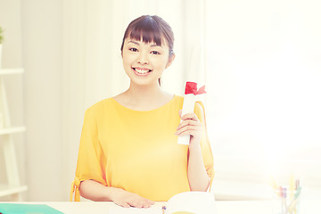 Image showing happy asian woman student with diploma at home