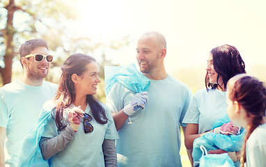 Image showing volunteers with garbage bags walking outdoors