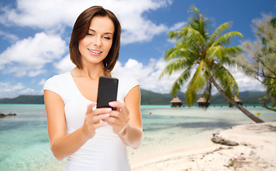 Image showing woman taking selfie by smartphone on beach