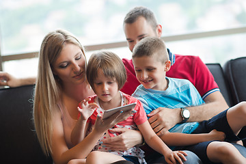 Image showing happy young couple spending time with kids