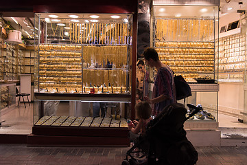 Image showing mother with  little girl in a stroller in front of  jewelry shop