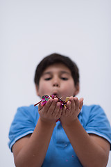 Image showing kid blowing confetti